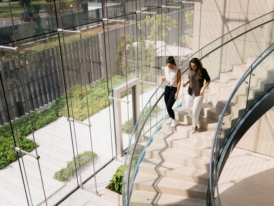 women walking down the stairs in a commercial office building